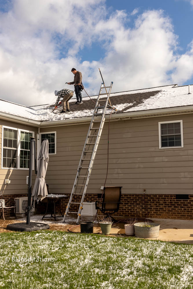 Clearing snow from roof prior to solar panel installation