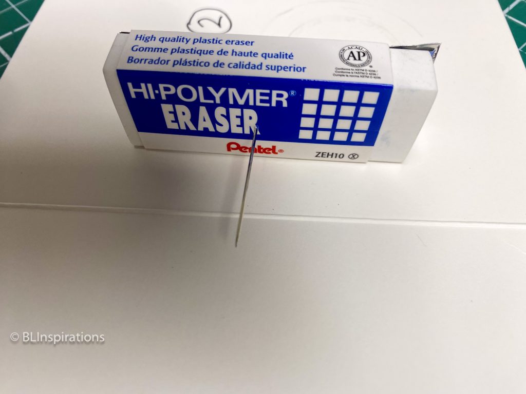 Needle in eraser with aluminum backing strips